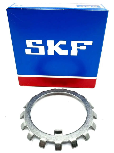 Pro Grade W11 Lock Washer For Bearings With 2.18 Inch Inner Diameter And 3.109 Outer Diameter 0.053 Inch Width placed beside SKF packaging.