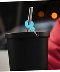 Blue charm from Six Colorful Straw Charm Covers Set For Cups And Parties on metal straw in black cup