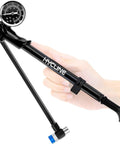 Hand holding high pressure shock pump up to 400 PSI for mountain bikes, showing alloy gauge and Schrader valve attachment.