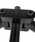 Lower bearing carrier puller head in black metal with dual hex bolts and central threaded shaft (close-up)