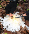 Hands striking 10 Pack Fire Starter Rod Magnesium Flint Ferrocerium Lighter for Outdoor Camping Survival on kindling outdoors
