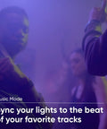 Party scene with people dancing, showcasing the 16.4ft RGB LED Light Strip With 16 Million Colors And Tunable White, Music Sync feature.