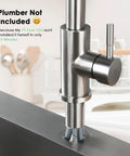 Close-up of Premium Stainless Steel Pull Down Kitchen Faucet With Three Mode Spray Head installed in a kitchen sink.