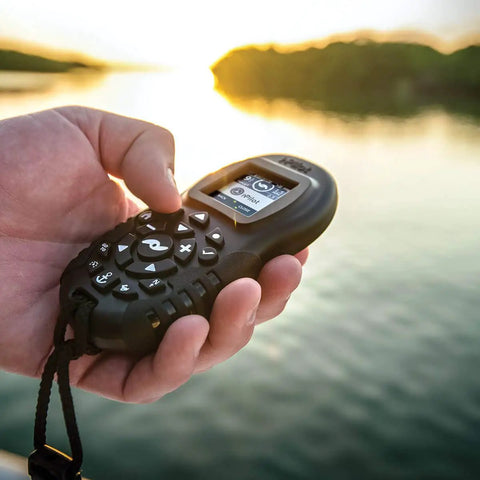 Hand holding Extra Bluetooth I Pilot System Remote For Trolling Motors second handheld controller with large LCD screen.