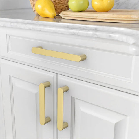 Premium Slick 5 Inch 128 mm Brushed Gold Cabinet Handles And Drawer Pulls For Kitchen Cupboards on white cabinet.