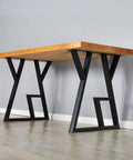 Table with Industrial Metal Furniture Legs 2 Pack For DIY Decor Projects 28 Inch High Square Tube Leg Black 24 Inch Wide Perfect For Coffee Tables Desks Dining Tables Shelves And Cocktail Tables seen from the side, featuring rustic wood top.