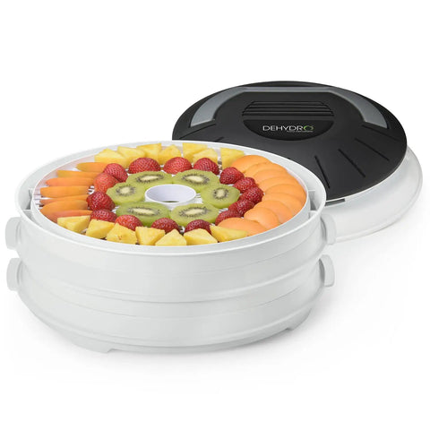 Electric Food Dehydrator With Four Stackable Trays And Top Mounted Fan displaying sliced fruits ready for drying.