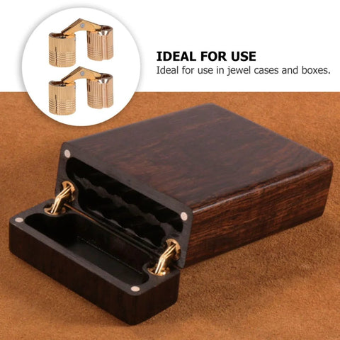 Two copper hidden bracket hinges for jewelry boxes; gold-tone recessed cabinet hardware.