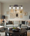 Living room with set of 4 oil rubbed bronze wall sconces with clear glass cylinders, upward mount, modern lighting fixtures.