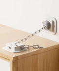 No Drill Anti Tip Furniture Anchor Kit with 3M Adhesive and adjustable steel cable securing furniture to wall.