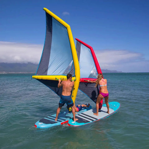 Inflatable Wing Foil And Sail For Wind Wing Foiling, Kitesurfing, Windsurfing, Surfing And Water Play, 4.2 Square Meter Large Wing Built With Premium Oxford Cloth And PVC, Waterproof, Wear Resistant, All Season Watersports Gear displayed on water with two people standing and one person lying down on boards.