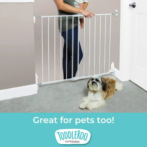 Hardware Mounted Metal Baby Gate For Stairs And Doorways, Walk Through Child Safety Barrier With Zero Threshold, Adjustable Up To Forty Inches Wide, Thirty Inches Tall, Crisp White in doorway with child and dog.