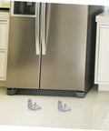 Heavy Metal Replacement Hinges For Commercial Fridge And Freezer Doors resting on a kitchen floor near a stainless steel fridge.