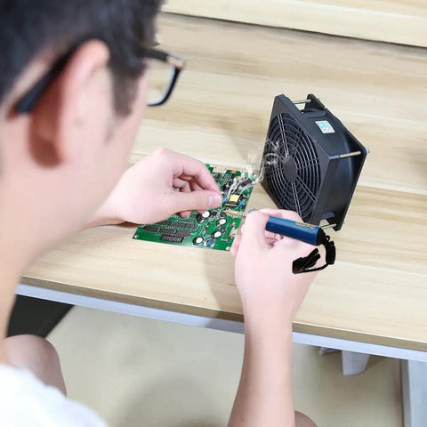 Person using Portable Solder Fume Extractor With Strong Suction, Includes Four Activated Carbon Filters during electronics soldering