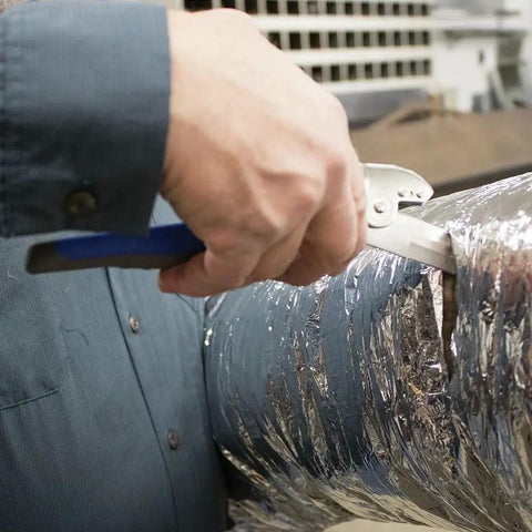 Person using Heavy Duty HVAC Cutter Tool With Built In Wire Cutter All Steel Double Edge Blades For Fiber Board Fiberglass And Flexible Ducts