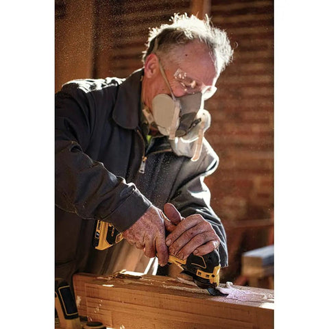 Man using Atomic 20V Max Cordless Oscillating Tool Bare Tool With Brushless Motor Dual Grip Variable Speed Trigger Universal Accessory Adapter