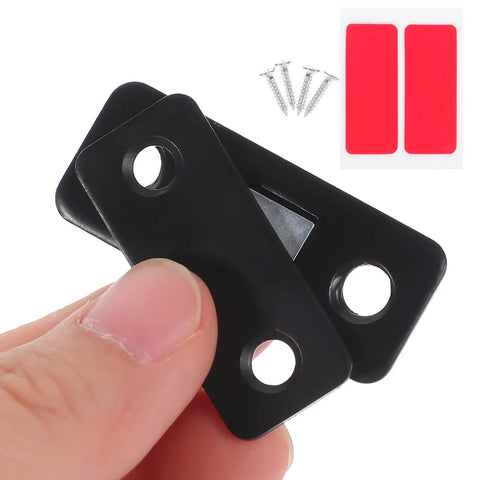 Magnetic Cabinet Door Catch Set 12 Piece Black Stainless Steel, close-up of two black catches held in hand with screws and adhesive strips visible.