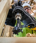 Self Feed Drill Bit 2 Inch With 7/16 Quick Change Shank in action on wood, showing three hardened cutting surfaces.