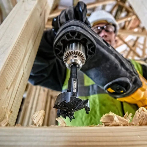 Self Feed Drill Bit 2 Inch With 7/16 Quick Change Shank in action on wood, showing three hardened cutting surfaces.