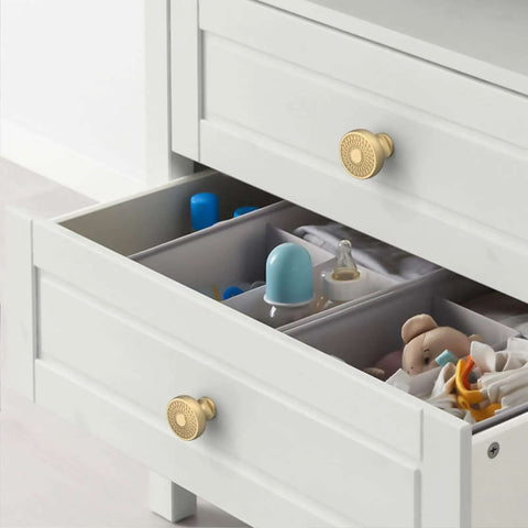 Dope Champagne Bronze Cabinet Knobs And Drawer Pulls on white dresser drawer with baby items visible inside