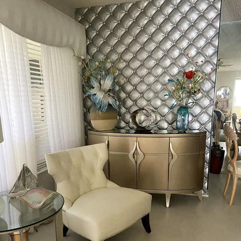 Room corner with Tufted 2x2 Seamless Glue Up Wall Panel Pack for 48 Sq Ft installed behind a modern dresser and chair.