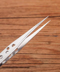 Close-up of a Five Piece Stainless Steel Tweezers Set for Electronics Repair and Crafting with anti-slip grip holes visible