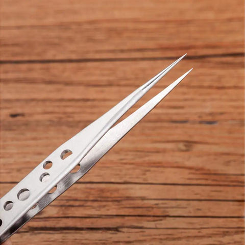 Close-up of a Five Piece Stainless Steel Tweezers Set for Electronics Repair and Crafting with anti-slip grip holes visible