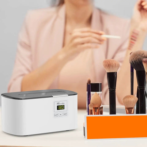 Ultrasonic Jewelry Cleaner 600ml Sonic Cleaner With Digital Timer next to makeup brushes on a table