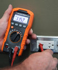 Hands using a multimeter with Replacement Test Lead Set, Right Angle Probes With Removable Alligator Clips, Universal Banana Inputs