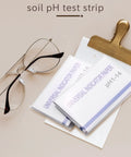 Complete 160 Strip PH Test Paper Kit 1 To 14 Range For Water Soil And Cosmetics With Color Coded Chart showcased with glasses.