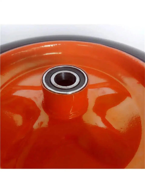 Built Tough 14 Inch Hella Durable Solid Rubber Caster Wheel For Heavy Duty Industrial Trolley and Mining Cart Replacement Knockout close-up of bearing and orange rubber.