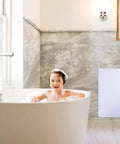 Child enjoying a bath next to Real Deal Plastic Drywall Access Panel 14 X 29 Inch With Concealed Hinge for easy access.