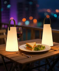 Rechargeable Cordless Outdoor Lanterns With Dope RGB Colors illuminating a table with food and wine on a balcony at night