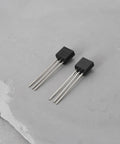 Two TO-92 transistors from Go-To Transistor Assortment Kit 100 Pcs NPN BC550C PNP BC560C for audio amplifiers and signal processing.