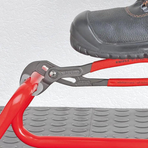 Cobra Water Pump Pliers With Seven And A Quarter Inch Length, V Jaw Style, Push Button Adjustment in use on metal surface