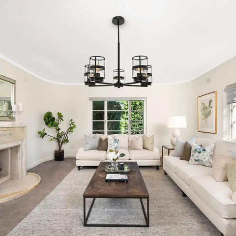 Living room with five light pendant lighting fixture with vintage farmhouse clear glass shades, height adjustable chandelier
