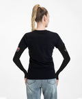 Back view of woman wearing Premium Ice Silk Cooling Arm Sleeves Feature An Iconic American Flag Print while sporting casual outfit.