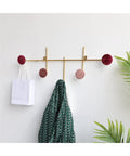 Slick Wall Mounted Coat Rack With Heavy Duty Adhesive Hooks And Key Holder For Mudroom Setup Easy Peel Design holding a green patterned jacket.