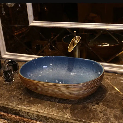USZWBY Vessel Sinks Bathroom Vessel Sink Oval Ceramic Washbasin Vintage Art Countertop Basin Utensils with Faucet Bathroom Bowl Sink on marble countertop.