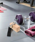 Wood Grip Trainer For Climbing And Lifting, Ergonomic Hand Strengthener With Detachable Design on gym floor with dumbbell and towel