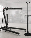 Heavy Duty Two Ton Folding Engine Hoist Paired With Three Quarter Ton Support Stand in a garage with smooth swivel casters.