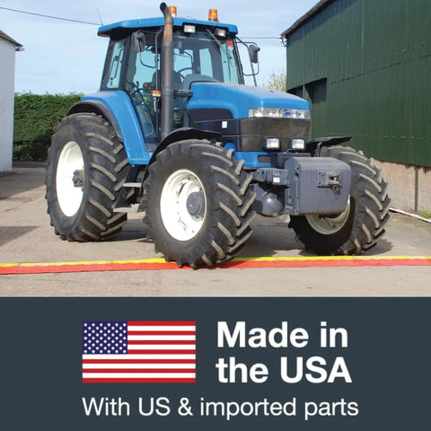 Tractor driving over Rugged Drive Over Cable Protector For 1.25 Inch Lines With Heavy Duty 17k Axle Load Drop Over Ramp