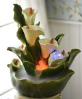Decorative multi-tier lotus water fountain with LED lights and green ceramic leaves for indoor tabletop display