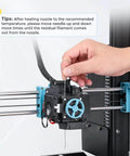 Inserting needle into 3D printer extruder for maintenance, part of Beefed Up Hardened Steel MK8 3D Printer Nozzles Set With Storage Box And Handy Tools