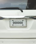 8 Pack Car License Plate Screw Caps And Bolt Covers Set installed on car license plate, showing black plastic head covers.