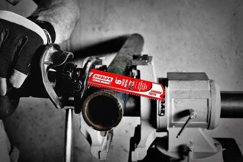 Diablo 9-inch carbide teeth reciprocating saw blade installed in metal lathe cutting a pipe.