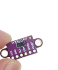 Top Shelf Vl530x Time Of Flight Laser Range Finder Breakout Module Purple Pcb Board I2c Interface viewed close-up in a hand.