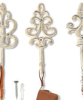 Distressed White Cast Iron Wall Hooks Set Of Three Dang Sturdy Farmhouse Coat Rack Hardware showcasing intricate designs with keychains.