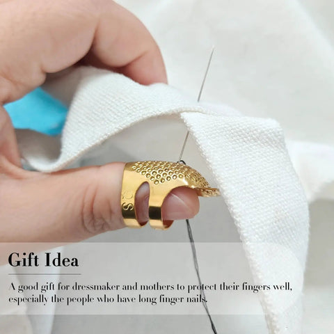 Close-up of hand sewing with 37 Piece Hand Sewing Tool Set With Big Eye Stainless Steel Needles, gold thimble, and thread on fabric.