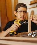 Person using Aluminium Hollow Door Anchor Set 10 Pieces For 0 To 5mm Hollow Doors with drill for installation.